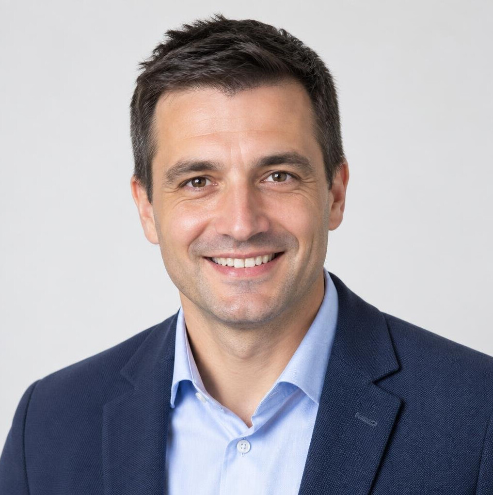 Studio portrait of a smiling man in business casual attire