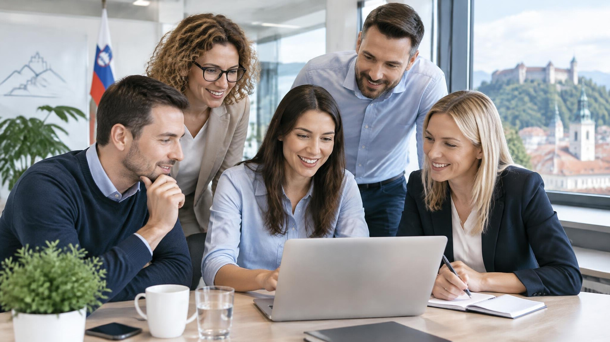 Team of professionals collaborating around a laptop in a modern office